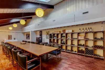 a large room with a table and chairs and wine racks at Montra Hotel Hanstholm in Hanstholm