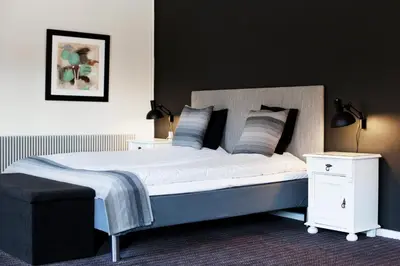 a bedroom with a large bed with two night stands at Montra Hotel Hanstholm in Hanstholm
