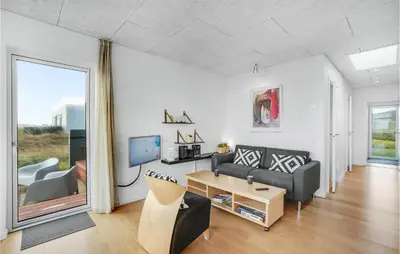 a living room with a couch and a table at One-Bedroom Holiday Home In Ulfborg in Ulfborg