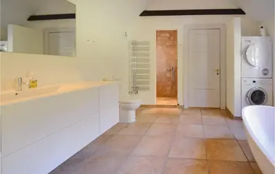 a white bathroom with a sink and a toilet at Venøhus in Struer