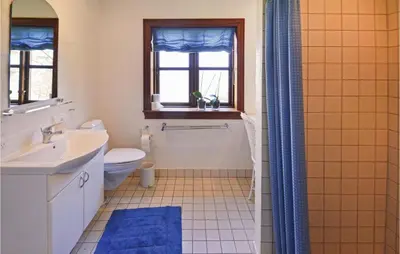 a bathroom with a sink and a toilet and a shower at Venøhus in Struer