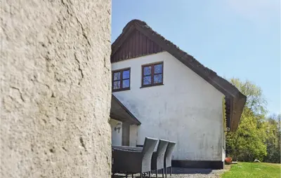 a group of chairs sitting outside of a building at Venøhus in Struer