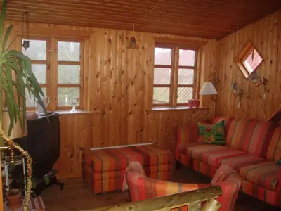 a living room with a couch and a tv at Country house in Karby