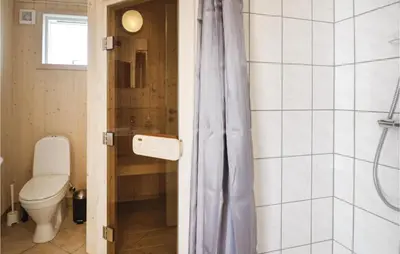 a bathroom with a toilet and a shower at Three-Bedroom Holiday Home In Fjerritslev in Fjerritslev