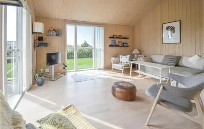 a living room with a couch and a table at Three-Bedroom Holiday Home In Fjerritslev in Fjerritslev