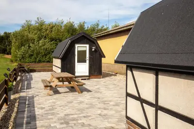 a shed with a picnic table and a bench at Bed and Breakfast Lemvig in Lemvig