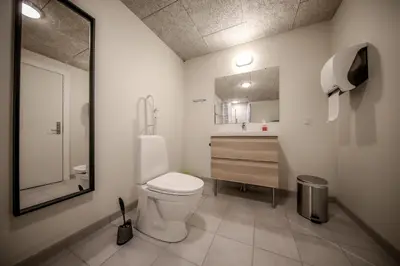 a bathroom with a toilet and a sink and a mirror at Bed and Breakfast Lemvig in Lemvig