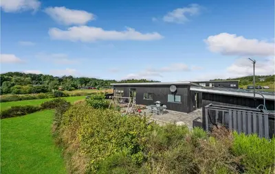 an aerial view of a black house in a field at Three-Bedroom Holiday Home In Spottrup in Spottrup