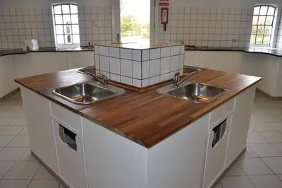 a kitchen with two sinks and a wooden counter top at Myrhoj Camping in Myrhøj