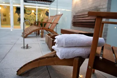 a pair of wooden benches with towels on them at Golf Hotel Viborg in Viborg