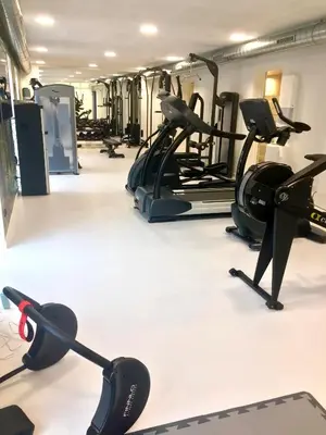 a gym with several treadmills and cardio machines at Golf Hotel Viborg in Viborg