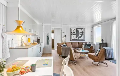 a kitchen and living room with a table and chairs at Two-Bedroom Holiday Home In Pandrup in Pandrup