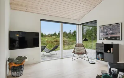a living room with a large tv and sliding glass doors at Three-Bedroom Holiday Home In Fjerritslev in Fjerritslev