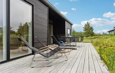 a group of chairs and a table on a deck at Three-Bedroom Holiday Home In Fjerritslev in Fjerritslev