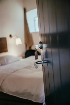 a door with a tag in a room with a bed at Sebber Kloster in Nibe