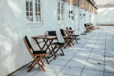 a row of tables and chairs on a patio at Sebber Kloster in Nibe