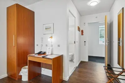 an office with a wooden desk in a room at Hotel Pinenhus in Glyngøre