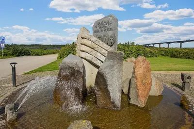 a statue in the water in a fountain at Hotel Pinenhus in Glyngøre