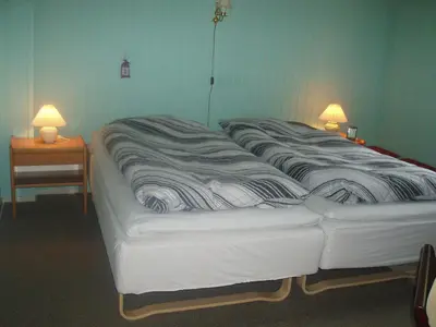 a large white bed in a room with two lamps at Glyngøre Bed & Breakfast in Glyngøre