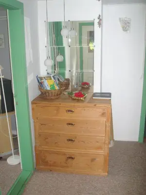 a wooden dresser with a mirror on top of it at Glyngøre Bed & Breakfast in Glyngøre