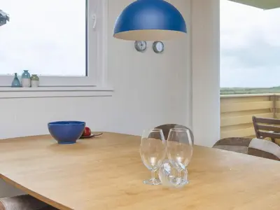 a dining room table with two wine glasses on it at 5 person holiday home in Lemvig-By Traum in Trans