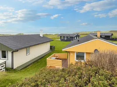 a group of houses in a field with grass at 5 person holiday home in Lemvig-By Traum in Trans