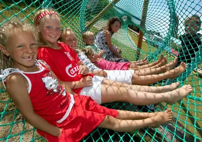 a group of girls sitting in a batting cage at Thyborøn Cottages in Thyborøn