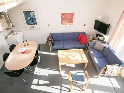 a living room with a blue couch and a table at 5 person holiday home in Vestervig-By Traum in Vestervig
