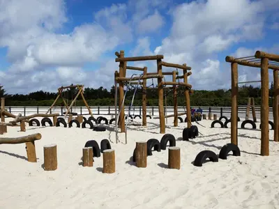 a playground in the sand with wooden play equipment at 5 person holiday home in Vestervig-By Traum in Vestervig