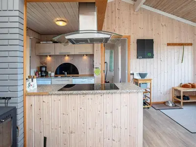 a kitchen with wooden walls and a large island at Luxury Spa Retreat near Sea - By Traum Ferienwohnungen in Ferring