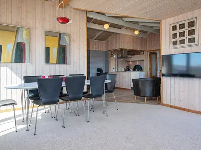 a dining room with a table and chairs and a kitchen at Luxury Spa Retreat near Sea - By Traum Ferienwohnungen in Ferring