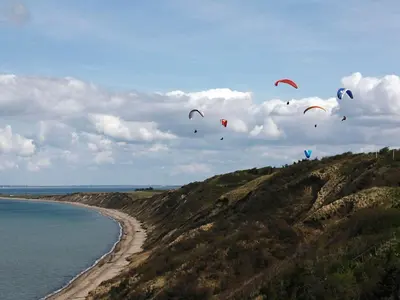 a bunch of kites flying in the sky over the ocean at 4 person holiday home in Struer in Struer