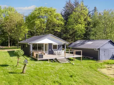 a small house with a porch and a deck at 5 person holiday home in Fur-By Traum in Fur