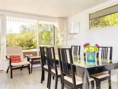 a dining room with a glass table and chairs at 5 person holiday home in Fur-By Traum in Fur