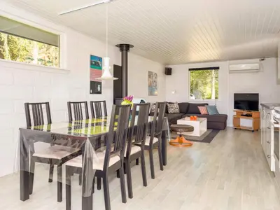 a dining room and living room with a table and chairs at 5 person holiday home in Fur-By Traum in Fur