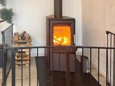 a wood stove with a fire inside of it at Luxury Retreat by Hostrup Beach - By Traum Ferienwohnungen in Spottrup