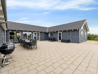 a patio with a grill and a house at Luxury Retreat by Hostrup Beach - By Traum Ferienwohnungen in Spottrup
