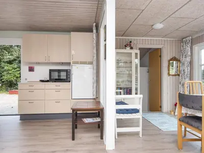 a kitchen with a refrigerator and a table and chairs at 8 person holiday home in Struer-By Traum in Struer