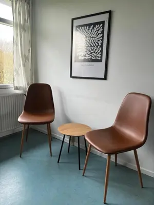 two chairs and a table in a room at Danhostel Aalborg in Aalborg