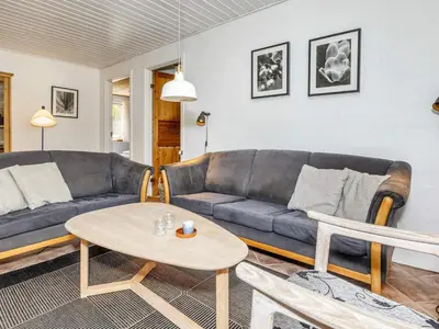 a living room with a couch and a table at 8 person holiday home in Højslev-By Traum in Højslev