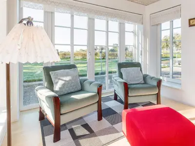 two chairs and a ottoman in a room with windows at 10 person holiday home in Fur-By Traum in Fur