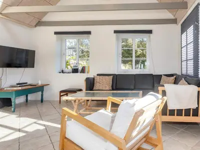a living room with a couch and a table at 10 person holiday home in Fur-By Traum in Fur