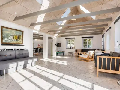a living room with a couch and a table at 10 person holiday home in Fur-By Traum in Fur