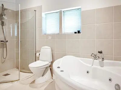 a bathroom with a toilet and a tub and a sink at 6 person holiday home in Thyholm in Thyholm