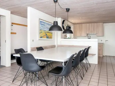a kitchen and dining room with a table and chairs at 12 person holiday home in Harboøre-By Traum in Harboør