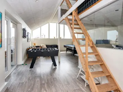 a living room with a loft bed and a staircase at 12 person holiday home in Harboøre-By Traum in Harboør