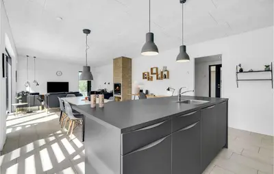 a kitchen and living room with a counter and a sink at Three-Bedroom Holiday Home In Thisted in Thisted