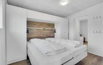 a white bedroom with a large bed with white sheets at Three-Bedroom Holiday Home In Thisted in Thisted