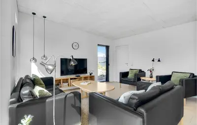 a living room with black leather furniture and a tv at Three-Bedroom Holiday Home In Thisted in Thisted