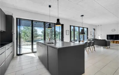 a kitchen and living room with a large island in a house at Three-Bedroom Holiday Home In Thisted in Thisted